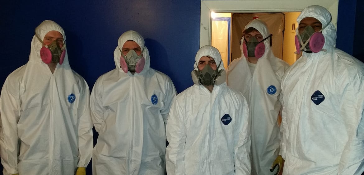 water damage restoration Phoenix specialists standing with mold remediation gear on